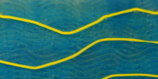 close up of blue fused glass with yellow lines