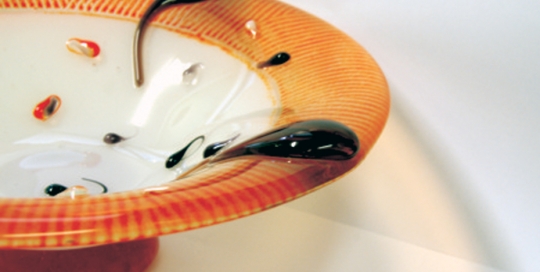 red and white striped fused glass bowl with drops of glass