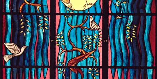 three panelled stained glass window of blue and red background with doves on branch