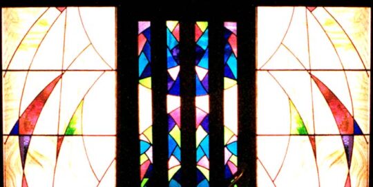 colourful large stained glass windows with light coming through