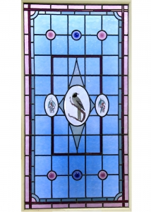 stained glass blue window with painted bird and flowers