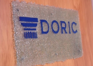 fused glass sign with doric logo in blue glass