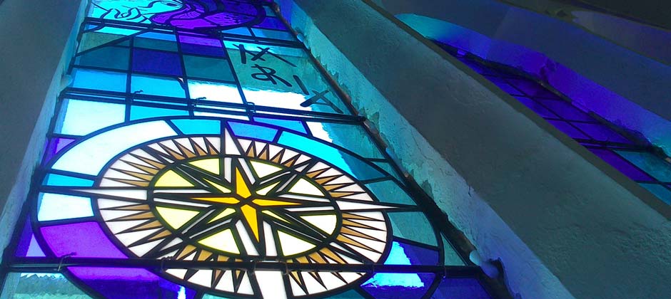 Mary Star of the Sea1 blue stained glass window from below in blue with yellow star