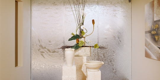 Decorative Slumped Glass partition with stone plinths in front