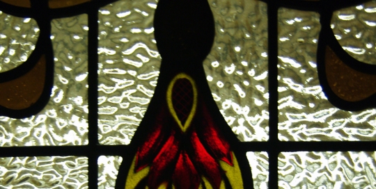 close up of yellow and red stained glass window