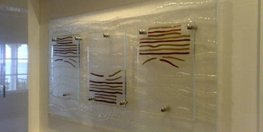 slumped glass wall art with three rectangles with brown lines attached to larger glass panel