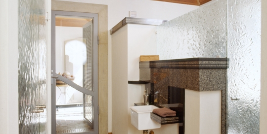 Slumped glass shower screen and doors to cupboard