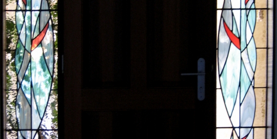 swirling coloured ribbons in door side panel stained glass