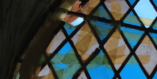 broken leadlight window being held together with tape