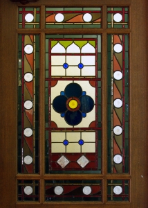 stained glass door panel with rondels and patterns