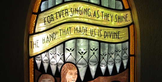 stained glass window of children playing instruments