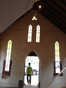 man in hi vis leaving through door of st johns pro cathedral