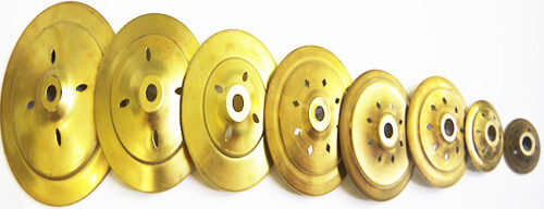 eight circular brass caps in various sizes