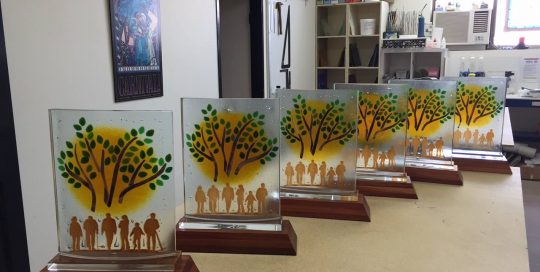 six trophies with people under a tree design