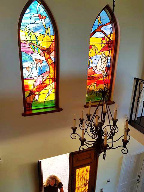 two arched stained glass windows in bright colours with Australian bird designs