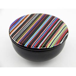fused glass container with black base and multi coloured striped lid