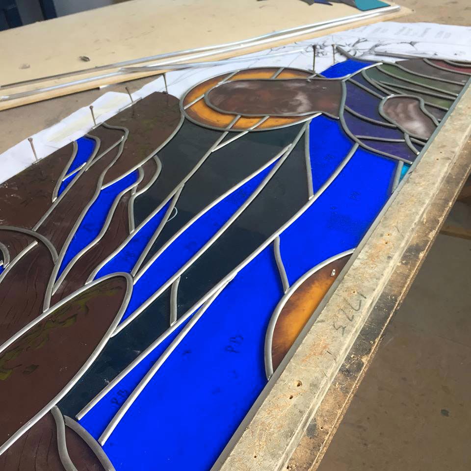 the holy family leadlight window being constructed on a bench