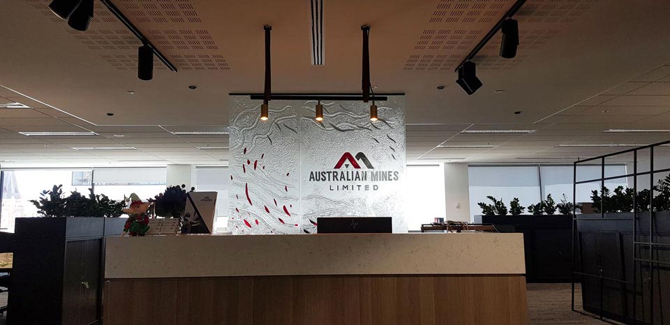 reception desk with clear textured kiln formed with logo in laminated coloured glass signage behind