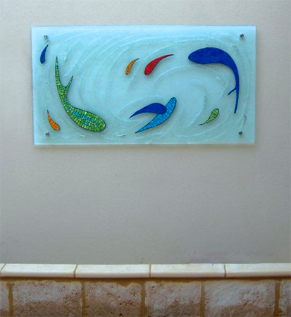 custom textured glass water feature with abstract fish swimming in a circle