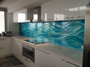 blue wave slumped glass splashback between white cabinetry