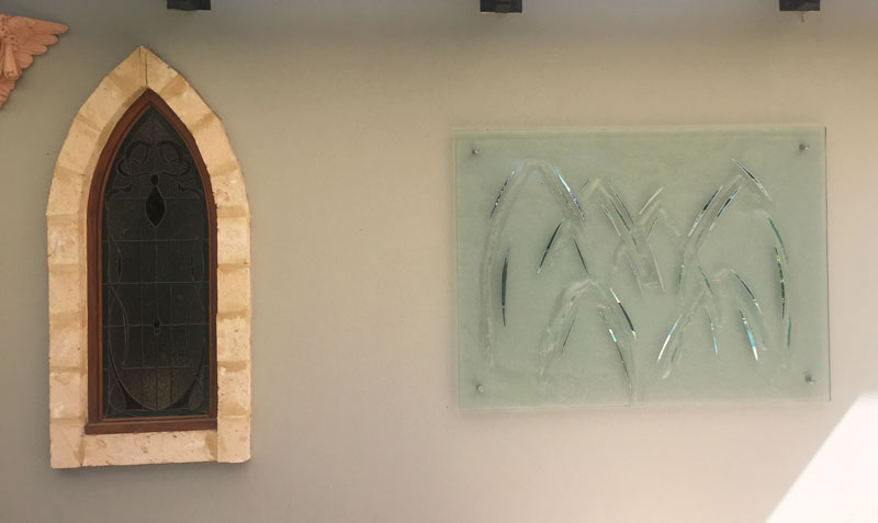 wall with arch stained glass window and kiln formed textured glass wall art