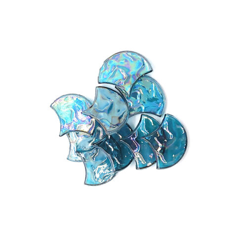 pile of blue transparent ornate glass mosaics in fan shape on white background