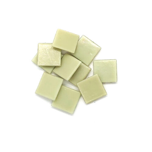 light yellow green 20mm glass mosaic with flat finish tiles in pile on white background