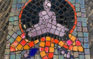 completed glass mosaic of buddah style figure on flower