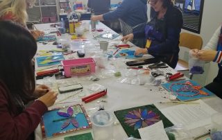 classroom with students working on mosaic pieces