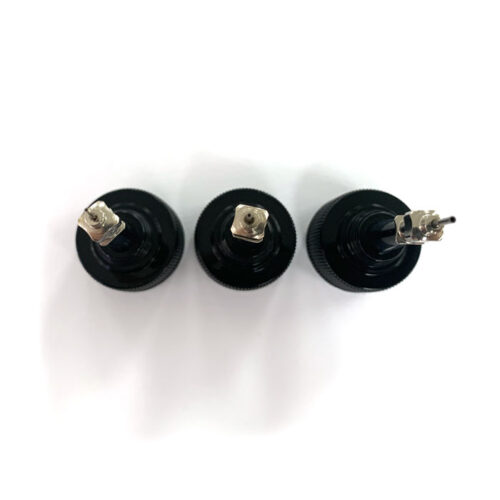 birds eye view of three bottle caps with various width metal tips