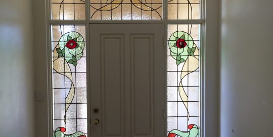federation style entrance with seven rose and clear textured stained glass designs