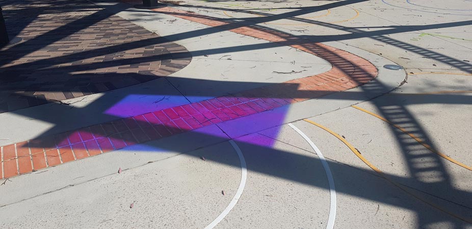 reflected light and shadow on concrete pathway