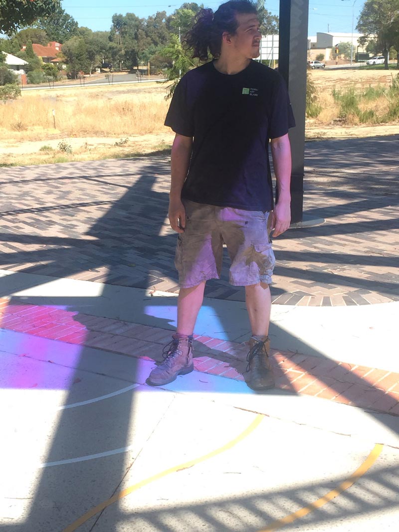 man standing under dichroic glass refraction