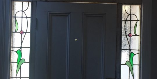 white door from inside with five jacaranda stained glass panels in a federation house