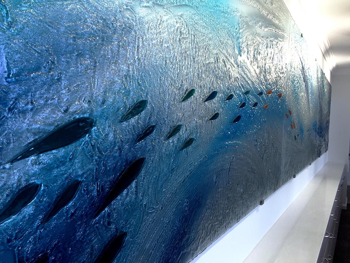 kiln formed glass installation in blue and white ocean colours and laminated glass shapes