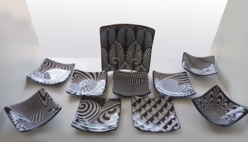 A full range of black and white geometric patterned glass plate six plates, three small bowls and one large bowl