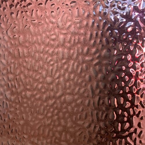 pink maroon glass with a bubbly like texture