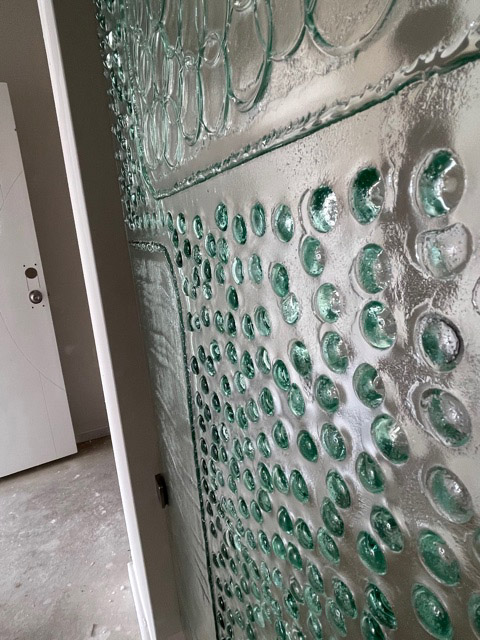 close up of feature slumped glass panel showing raised dots