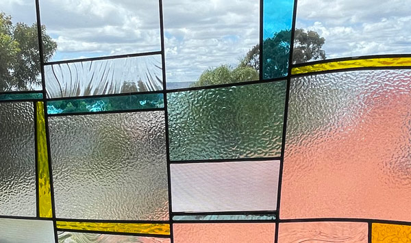 close up of blue yellow and clear leadlight stained glass