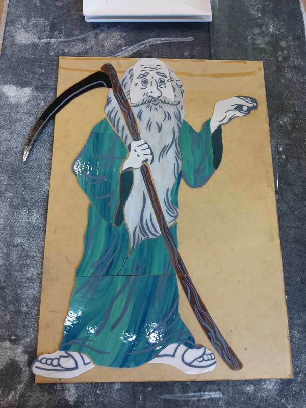 father time design with some cut and painted pieces placed