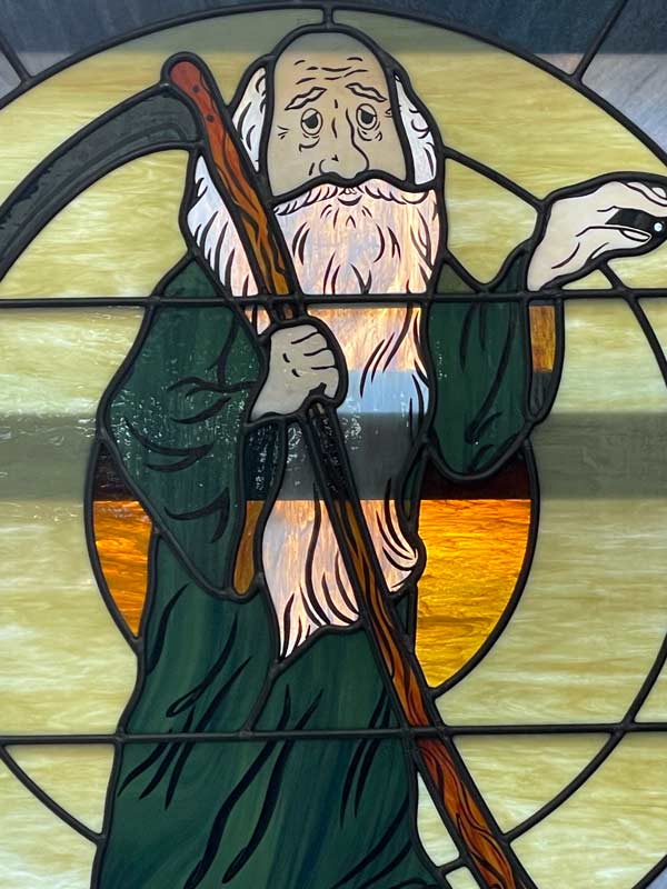 close up of father time in stained glass