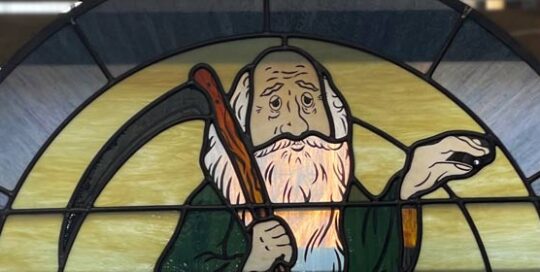 close up of father time in stained glass