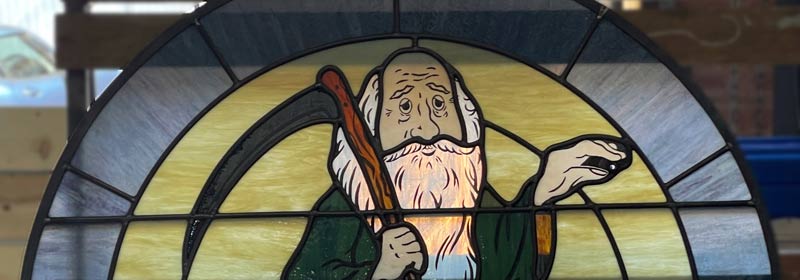 close up of father time in stained glass