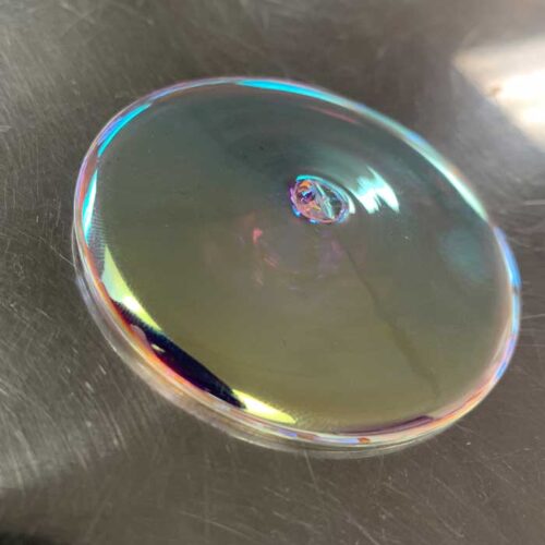 dichroic glass circle on dark background