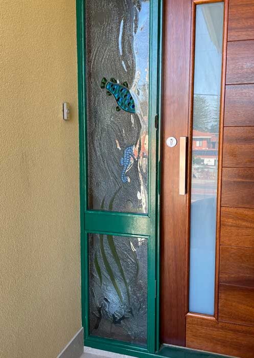 seahorse and fish in slumped laminated clear textured window at front side door