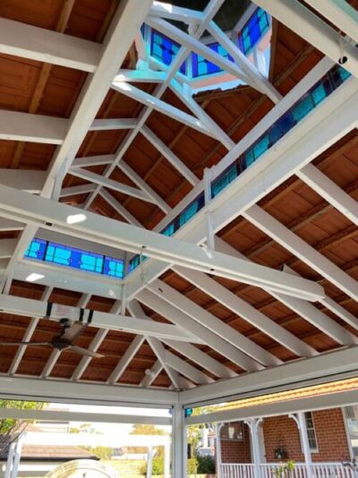 underside of restored pergola with stained traditional glass windows