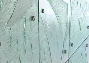 close up of whale tails in slumped glass panels