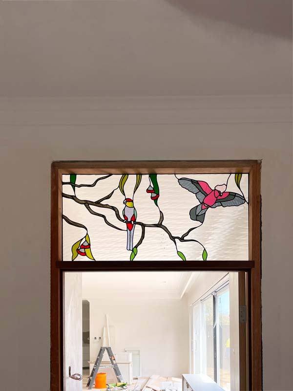 stained glass window above door with australian birds and tree