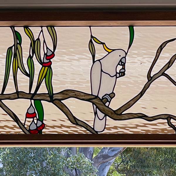 stained glass window in multiple panel with cockatoo and gum leaves