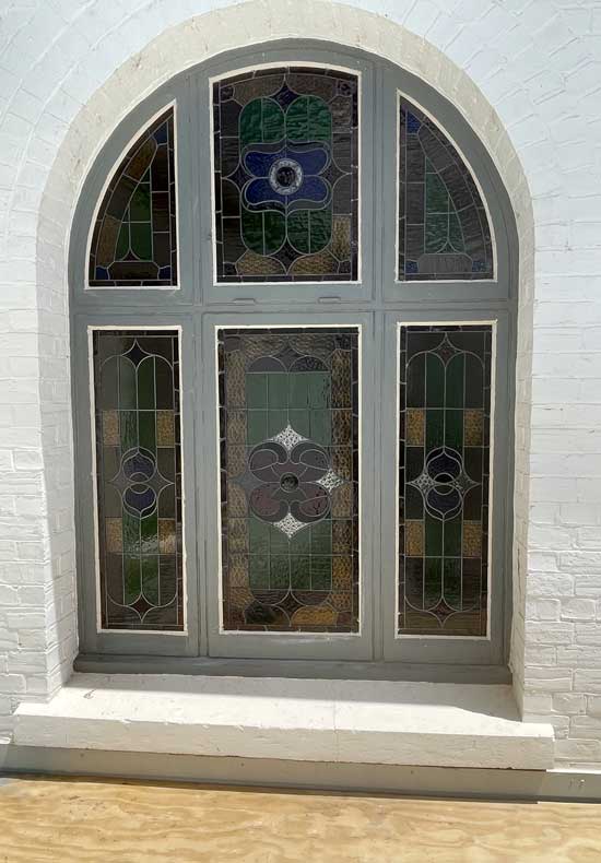 outside of arched stained glass window